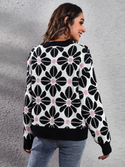 Black floral jacquard knit sweater with pink accents, crew neck, long sleeves.