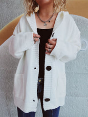 White chunky knit hooded button-down cardigan with pockets and dark buttons.