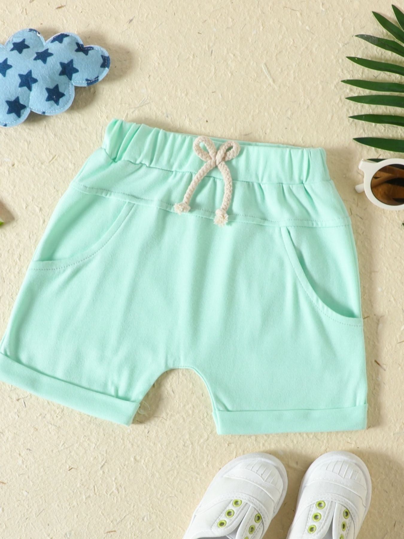 Light Green baby shorts with drawstring waist and pockets.