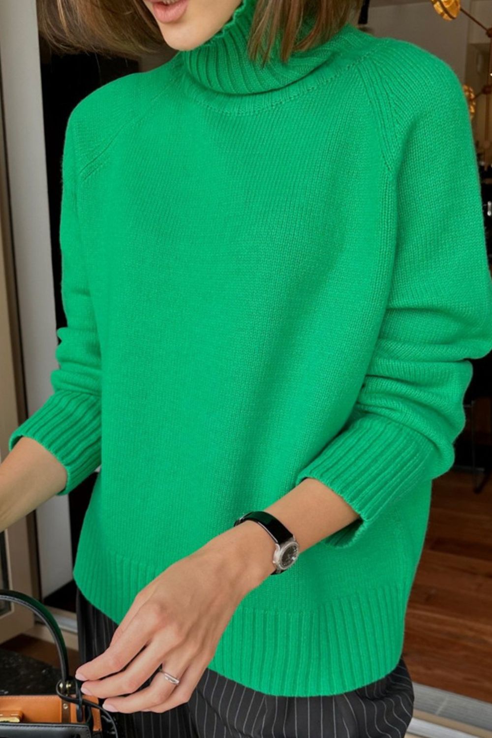 Mid Green cashmere turtleneck sweater with raglan sleeves and ribbed cuffs and hem.