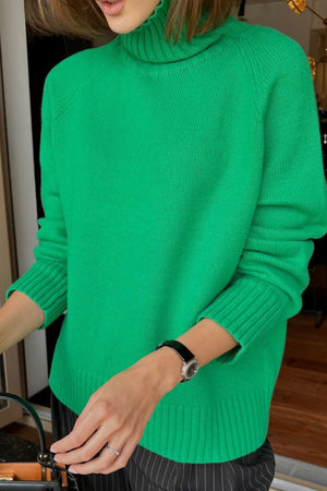 Mid Green cashmere turtleneck sweater with raglan sleeves and ribbed cuffs and hem.