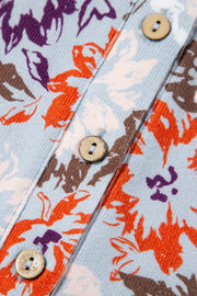 Floral jumpsuit with cap sleeves and button detail, featuring a colorful floral print.