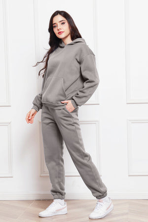Gray relaxed fit hoodie with kangaroo pocket and matching joggers.
