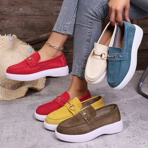 Chic loafers with gold horse-bit detail in red, yellow, brown, blue, and white.