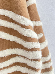 Tan and white textured stripe knit crewneck sweater with fuzzy stripes.