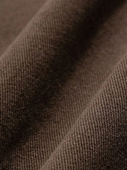 Wide-leg trousers in coffee brown fabric with visible texture and pleats.