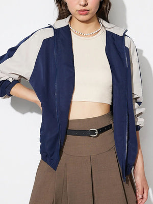 Colorblock raglan sleeve bomber jacket in dark blue and beige with a zip front.