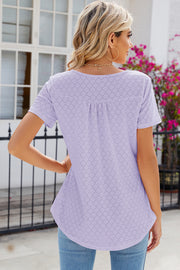 Lavender eyelet yoke gathered henley shirt with short sleeves and a curved hem.