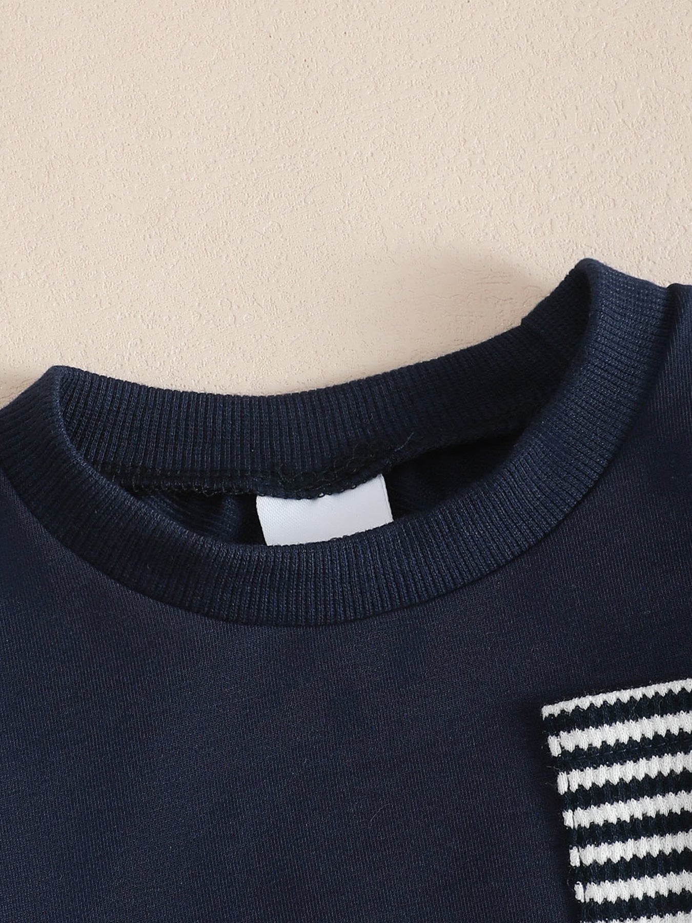 Children's navy cotton sweatshirt with striped pocket detail