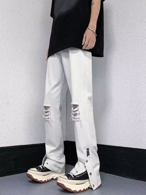 White distressed loose-fit jeans with snap detail and adjustable hem