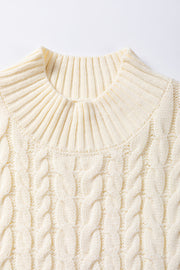 Ivory cable knit mock neck vest with ribbed collar and chunky knit texture.