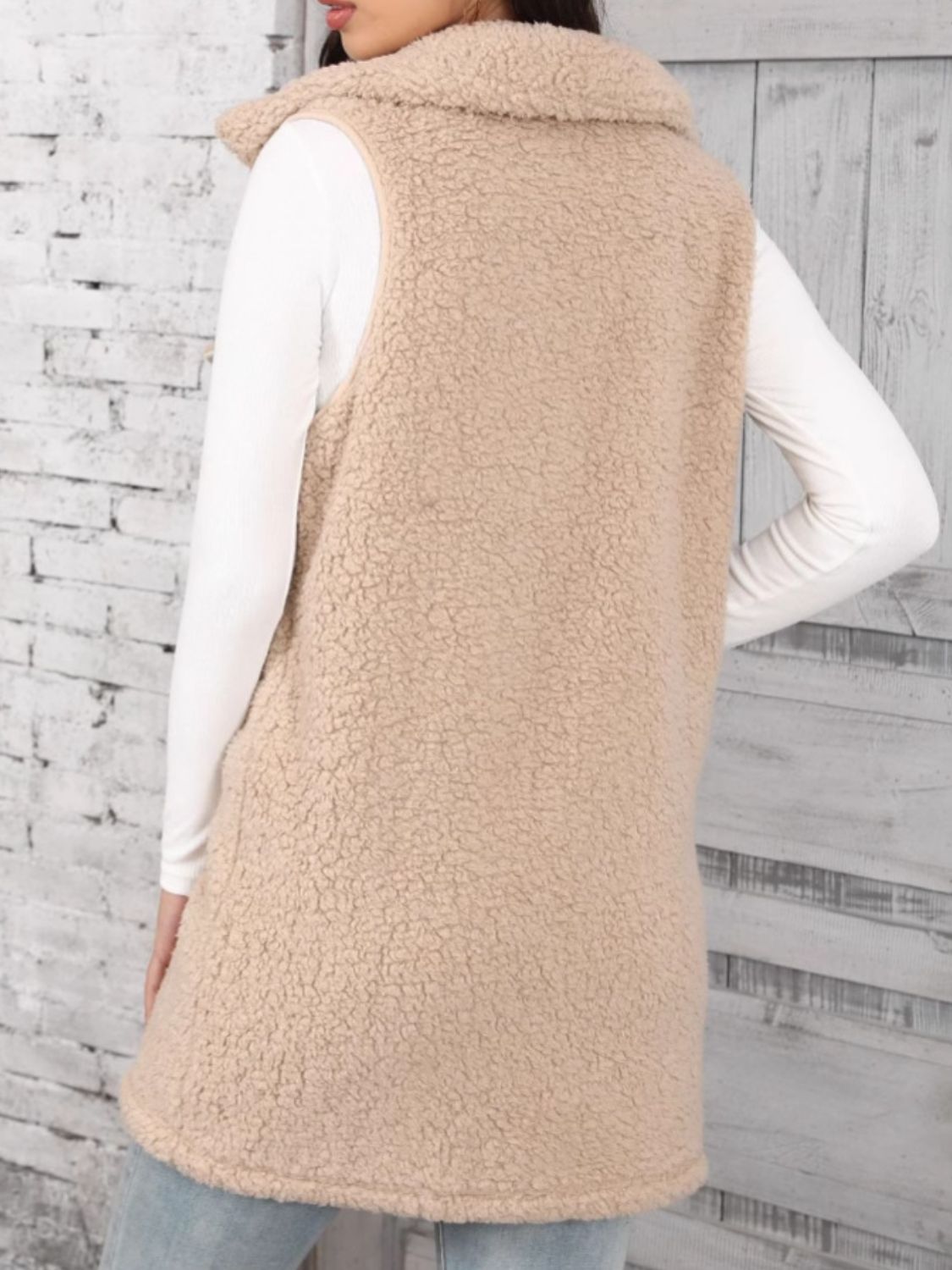Tan sherpa utility vest with collar, button front, and full length.