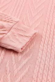 Pale blush knit sweater with chevron and textured sleeve details.