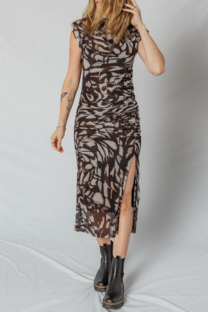 Brown abstract print ruched midi dress with cap sleeves and a high slit.