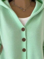 Green hooded knit cardigan with button front and white tank top.