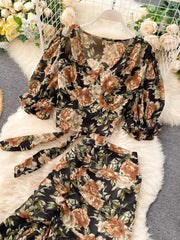 Chic floral crop top and pants set with puff sleeves and a tie waist in black.