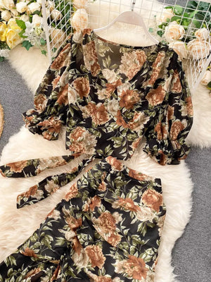 Chic floral crop top and pants set with puff sleeves and a tie waist in black.