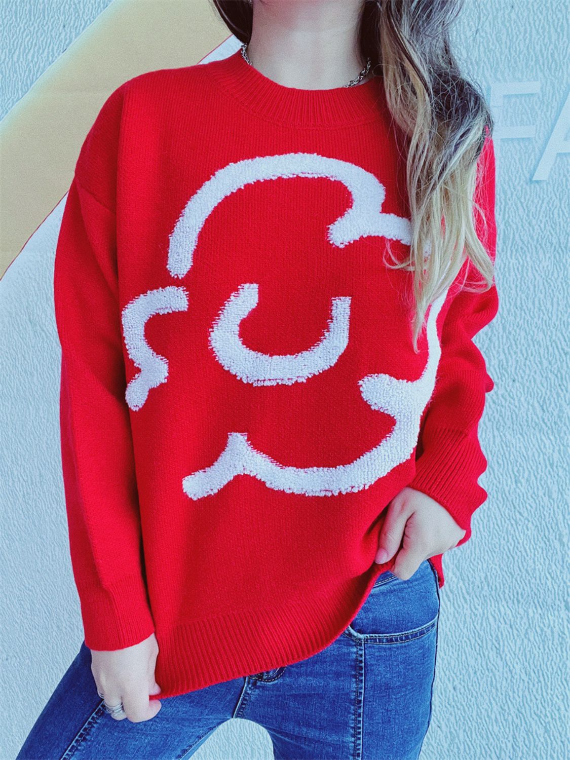 Red acrylic sweater with white cloud intarsia pattern, crew neck, long sleeves.