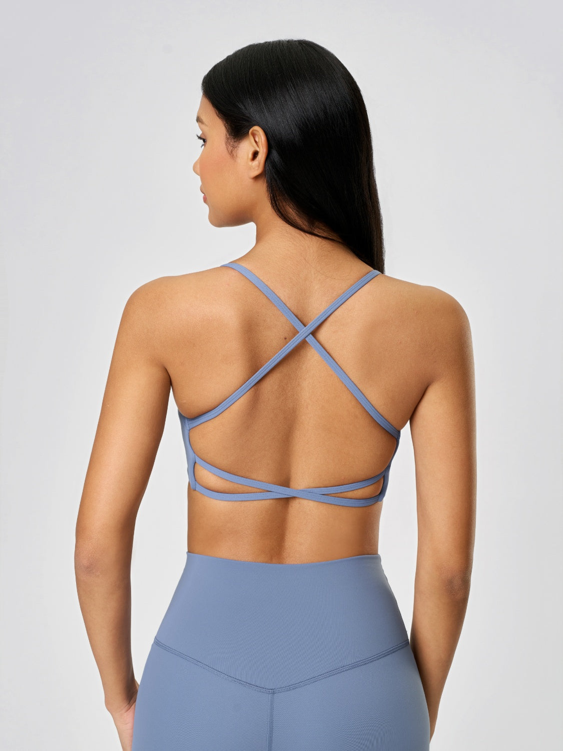 Strappy back active crop top in Dusty Blue with crisscross back detail.