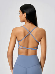 Strappy back active crop top in Dusty Blue with crisscross back detail.