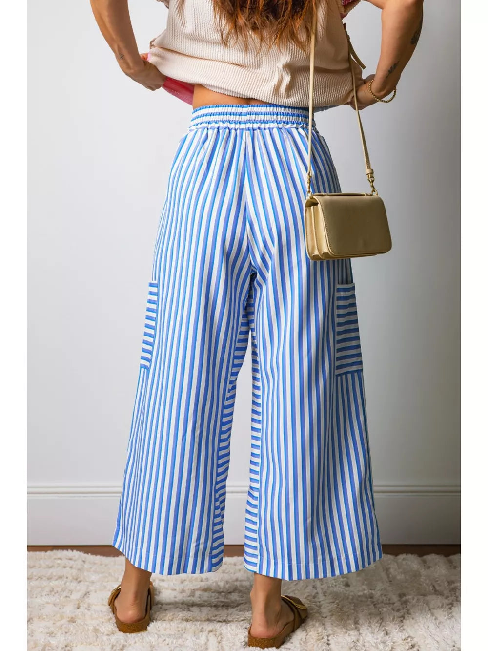 Maternity wide-leg ankle pants with blue and white stripes, pockets, and drawstring waist.