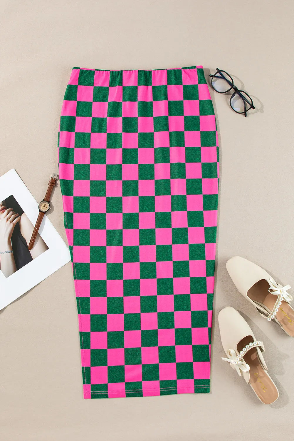 Checkerboard slit midi skirt in hot pink and green, with a side slit detail.