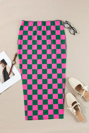 Checkerboard slit midi skirt in hot pink and green, with a side slit detail.
