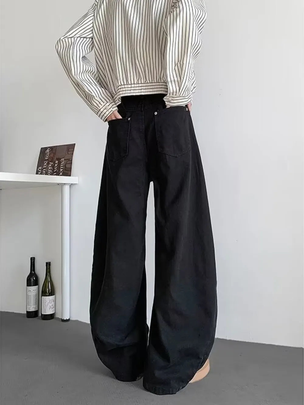 Black oversized men's sweatpants with pockets and a baggy fit.
