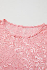 Dusty pink lace blouse with a round neckline and intricate floral pattern.