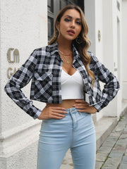 Cropped black and white plaid shirt jacket with buttoned front and chest pockets.