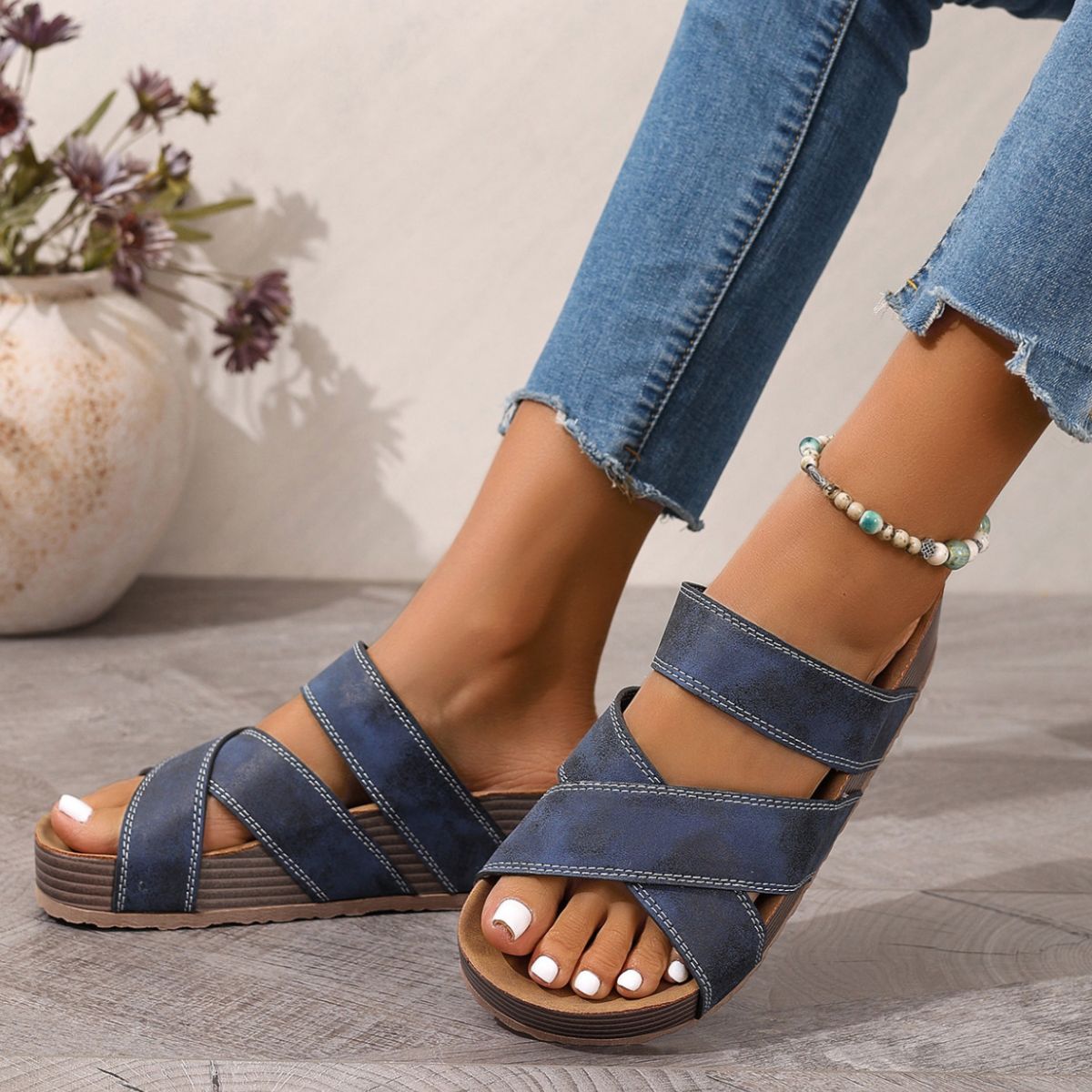 Blue criss-cross platform sandals with open toe and chunky sole.