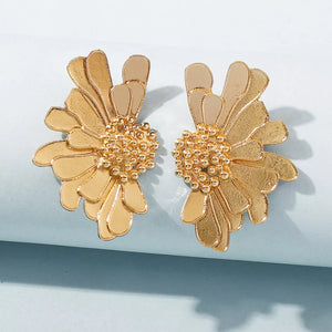 Textured gold flower stud earrings with beaded center and layered petals.