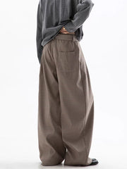 Men's wide leg check trousers in beige and brown with a relaxed fit.