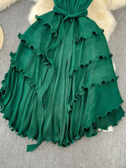 Dark green ruffled tiered midi dress with belted waist and frill trim.