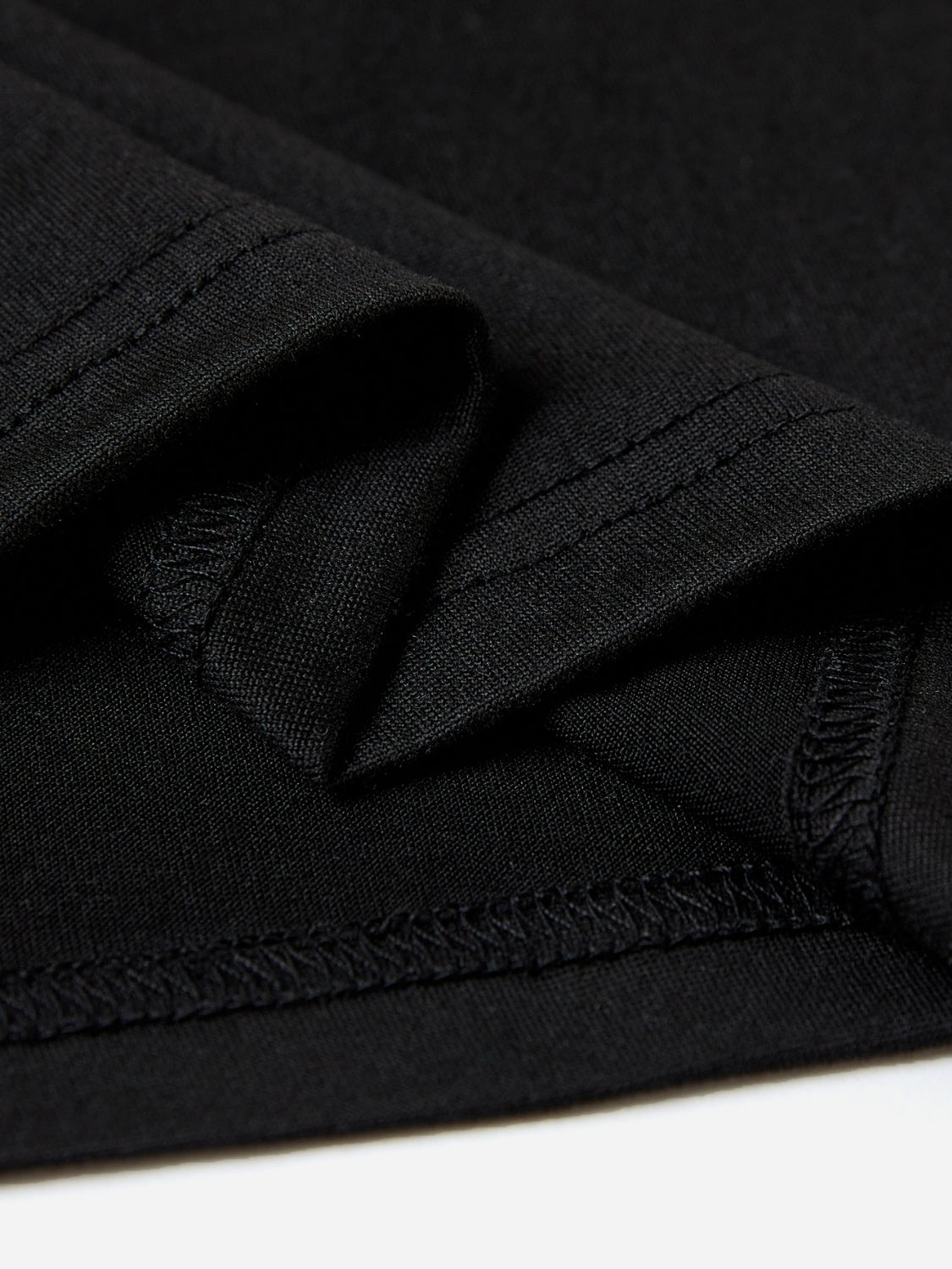 Black t-shirt detail showing fabric texture and stitching
