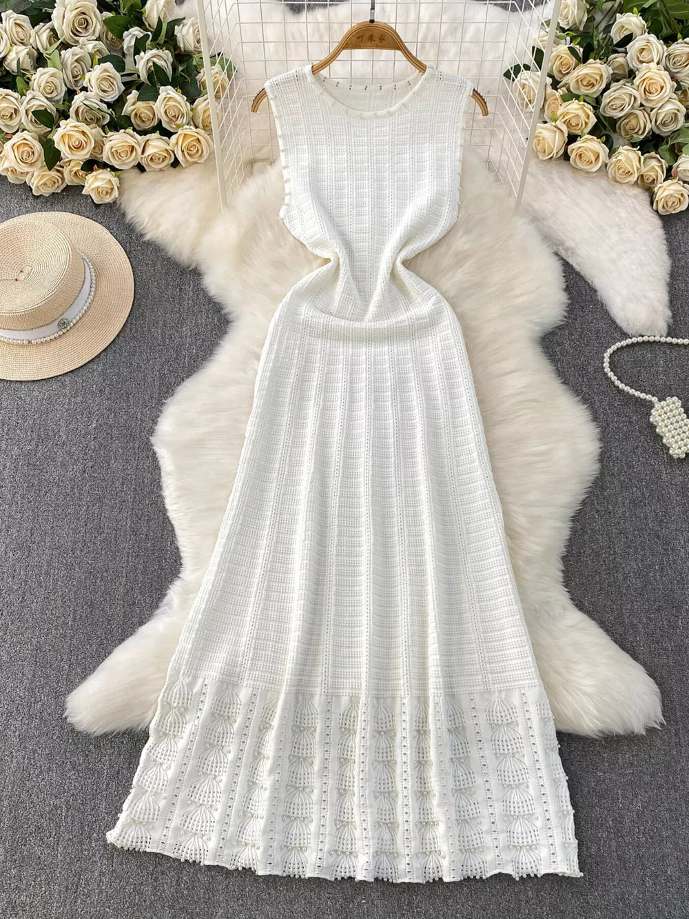 White knit midi dress with textured pattern and cutout details