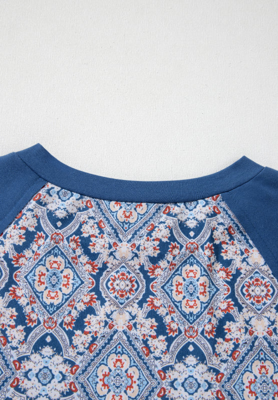 Dusty blue bohemian print blouse with bell sleeves and a crew neck.