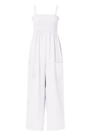 White smocked bodice palazzo jumpsuit with wide legs and side pockets.