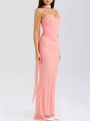Pink sweetheart tube top and flowy maxi skirt set with ruched bodice and sheer overlay.