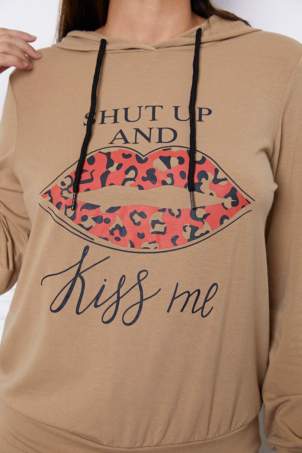 Khaki hoodie with leopard print lips and "Kiss Me" graphic.