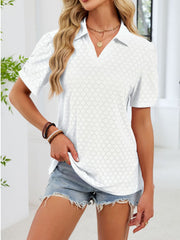 White eyelet ruched short sleeve blouse with a collared neckline.
