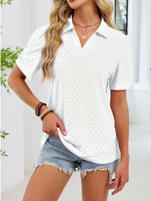 White eyelet ruched short sleeve blouse with a collared neckline.