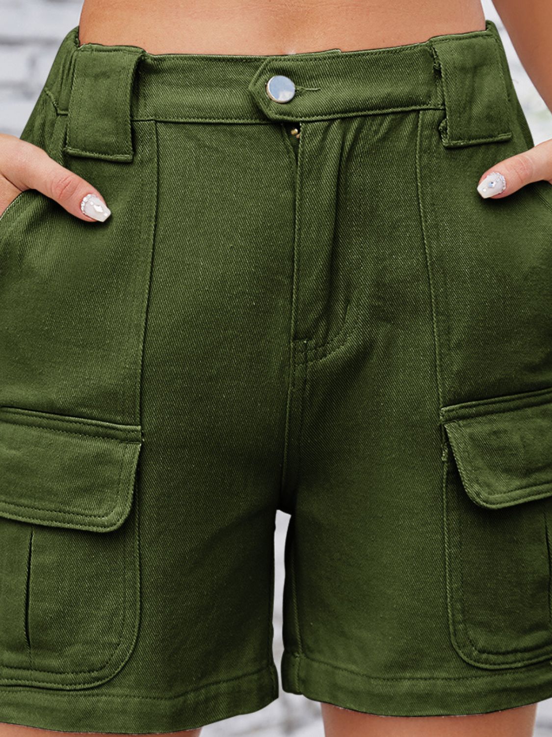 Army green denim cargo shorts with high waist and utility pockets.