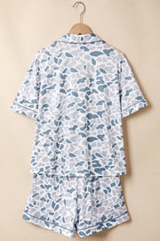 Blue camouflage print two-piece pajama set with button-down top and shorts.