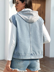 Light blue denim hooded vest with grey hood, worn over a white long sleeve shirt.