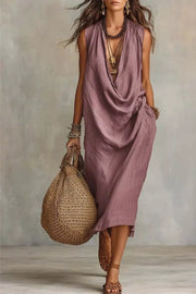 Dusty Pink cowl neck midi dress with pockets, sleeveless, relaxed fit, styled with layered necklaces and bracelets.