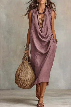 Dusty Pink cowl neck midi dress with pockets, sleeveless, relaxed fit, styled with layered necklaces and bracelets.