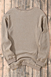 Khaki textured ribbed crewneck pullover sweater with long sleeves and crew neckline.
