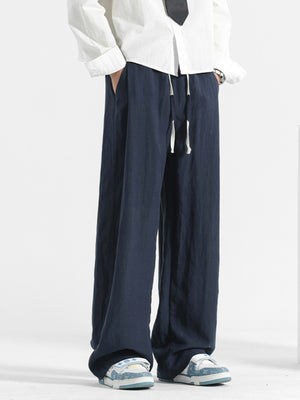 Men's navy blue loose fit drawstring pants with a wide leg.