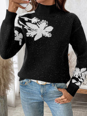 Black mock neck knit sweater with white floral embellishments and subtle sparkle detail.